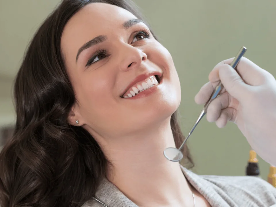 Patient checking her new smile in a mirror